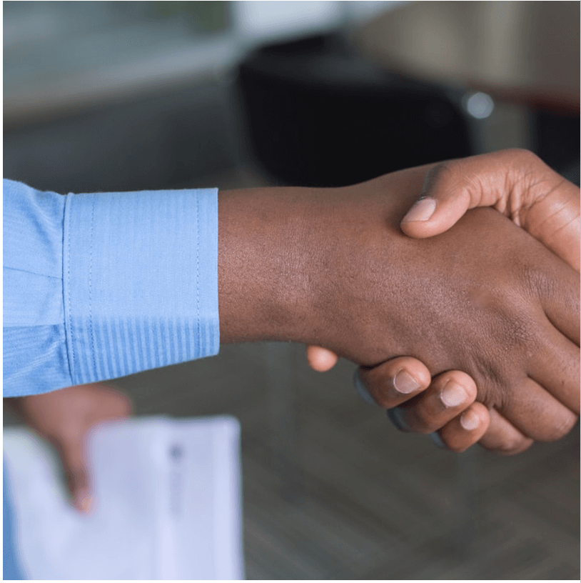A client shaking hands with a business owner.