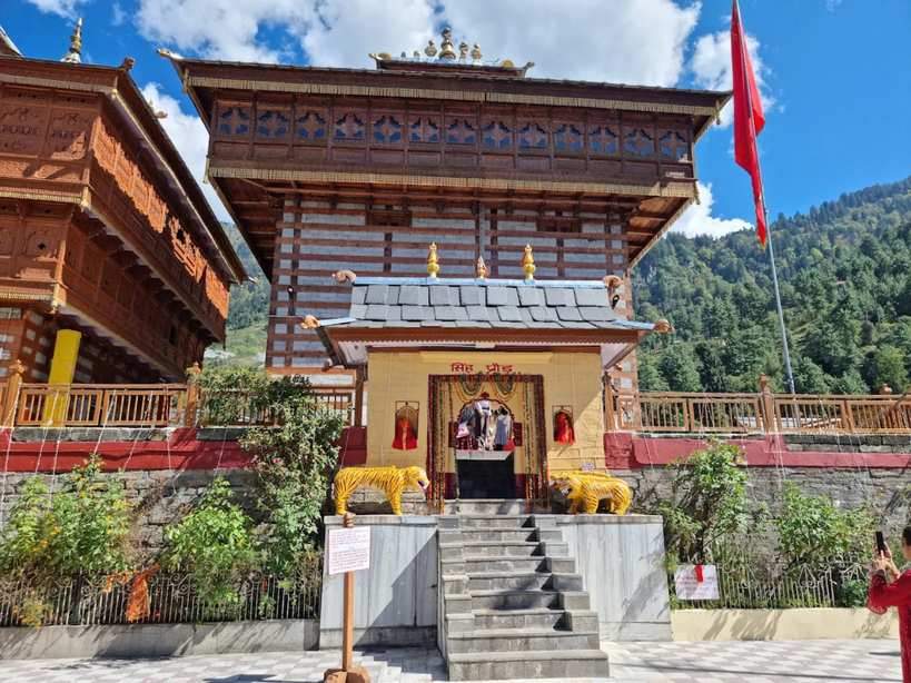 Entrance of Bhimakali Temple in Sarahan Himachal Pradesh with wooden architecture and lion statues