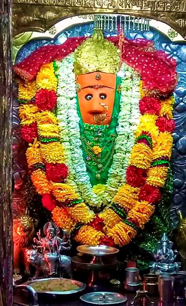 Maa Chamunda Devi idol adorned with flower garlands inside Chamunda Devi Temple Himachal Pradesh