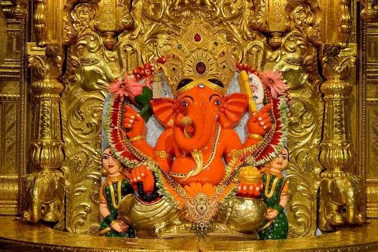 Lord Ganesha idol at Siddhivinayak Temple Mumbai decorated with gold ornaments and flowers