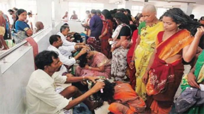 Devotees performing head tonsure ritual at Tirumala temple as an offering to Lord Venkateswara.