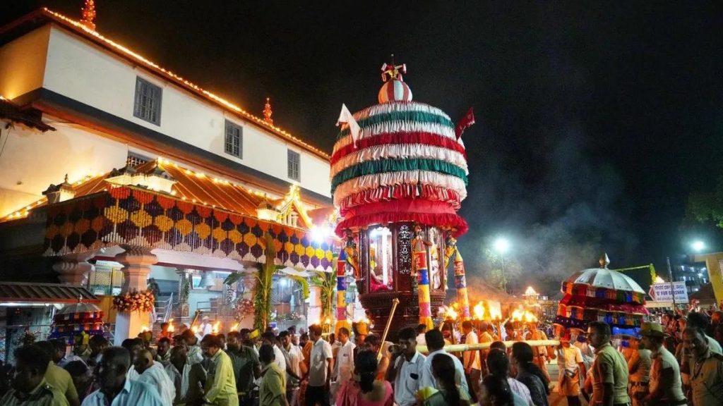 Dharmasthala temple festival with decorated chariot and devotees participating
