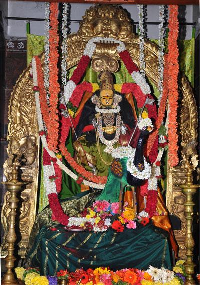 Decorated idol of Goddess Chamundeshwari adorned with flowers and ornaments inside Mysuru temple