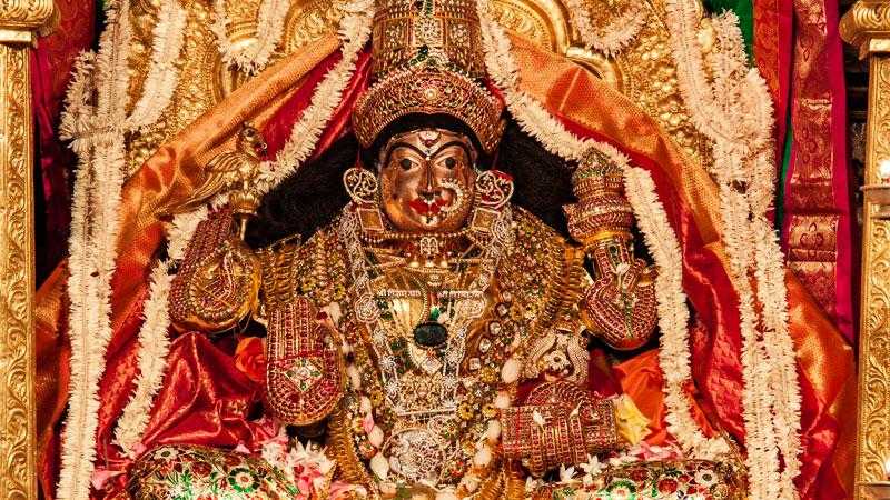 Golden idol of Goddess Sharadamba at Sringeri temple decorated with jewelry and flowers