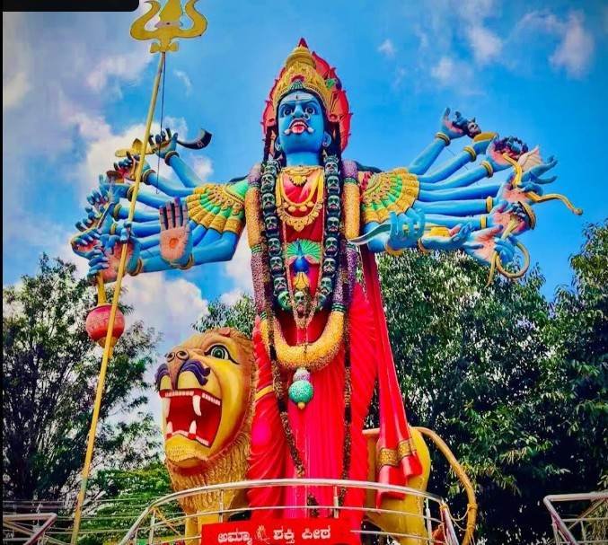 Massive blue-colored Goddess Kateramma statue with lion vehicle at Hoskote Kambalipura Temple.