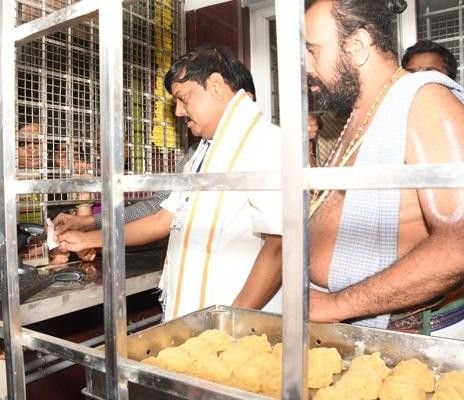 TTD staff preparing and distributing sacred Tirupati Laddu prasadam inside Tirumala Temple kitchen