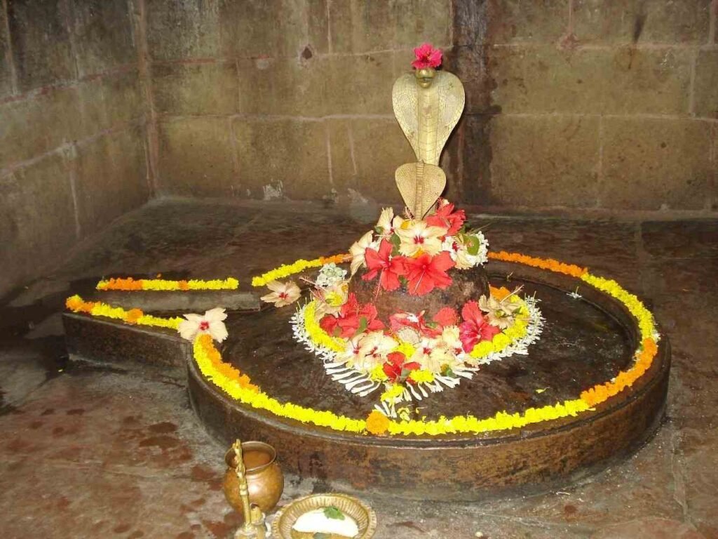 Sacred Shiva Lingam decorated with flowers inside Mukteswara Temple Bhubaneswar.