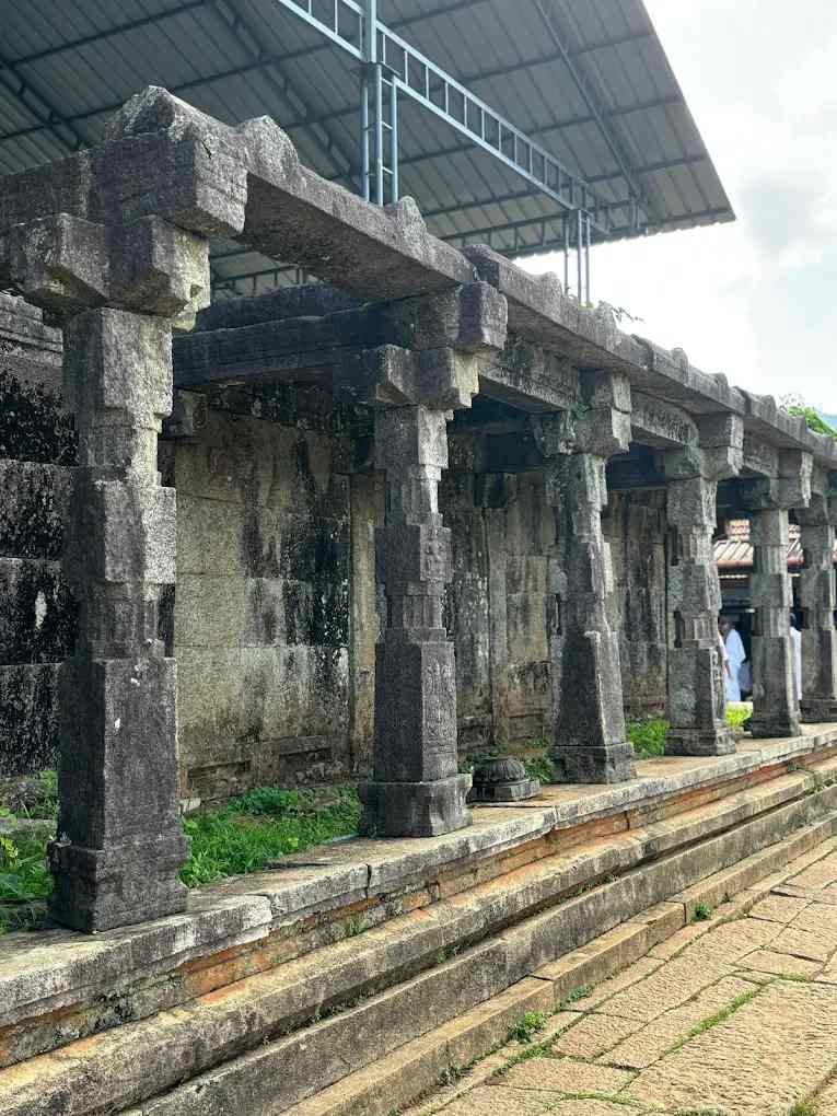Ancient stone corridor and pillars at Thirunelli Sree Maha Vishnu Temple in Wayanad Kerala