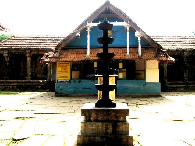 Temple courtyard with traditional lamp pillar at Thirunelli Temple Kerala