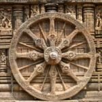Intricately carved stone wheel at Konark Sun Temple representing the ancient sundial design.