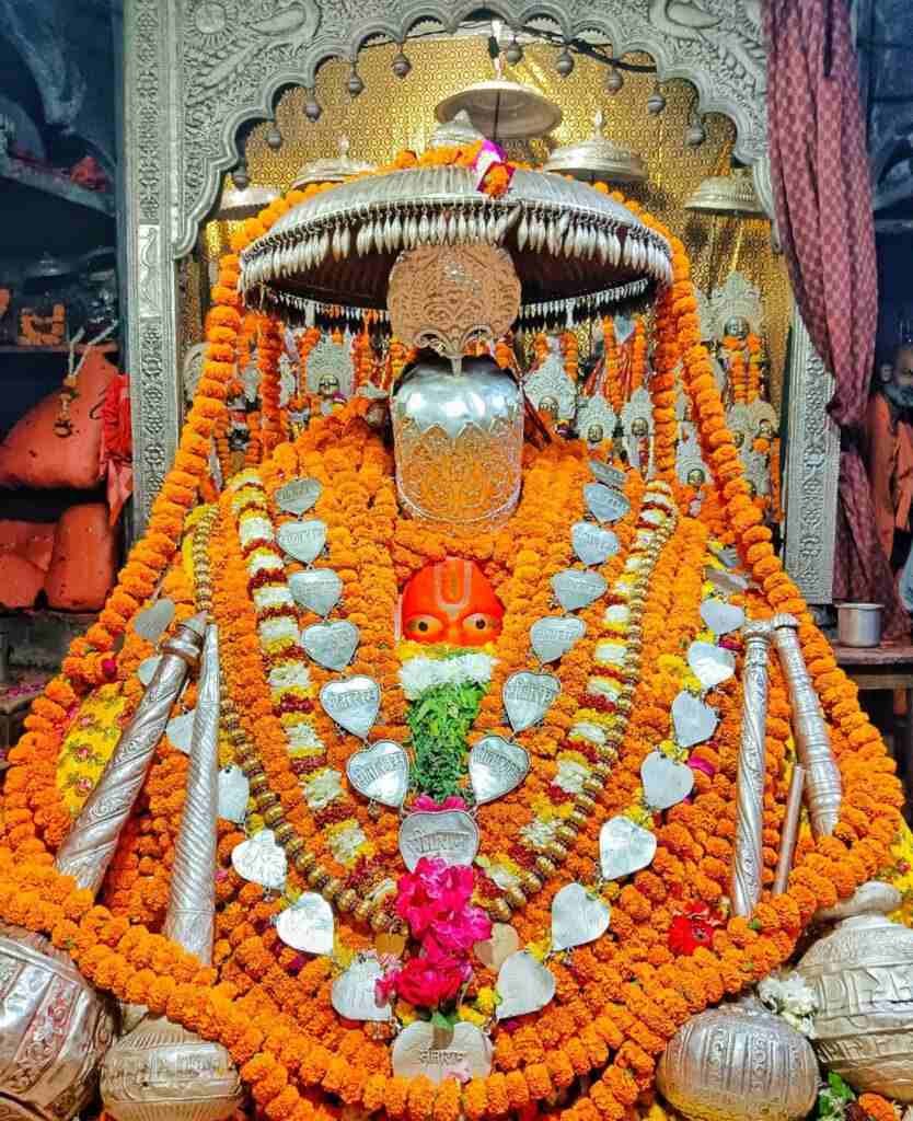 Decorated idol of Lord Hanuman at Hanuman Garhi Temple in Ayodhya adorned with garlands, silver ornaments, and sacred offerings.