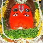 Sacred idol of Lord Hanuman at Karmanghat Hanuman Temple in Hyderabad decorated with flowers and traditional ornaments.