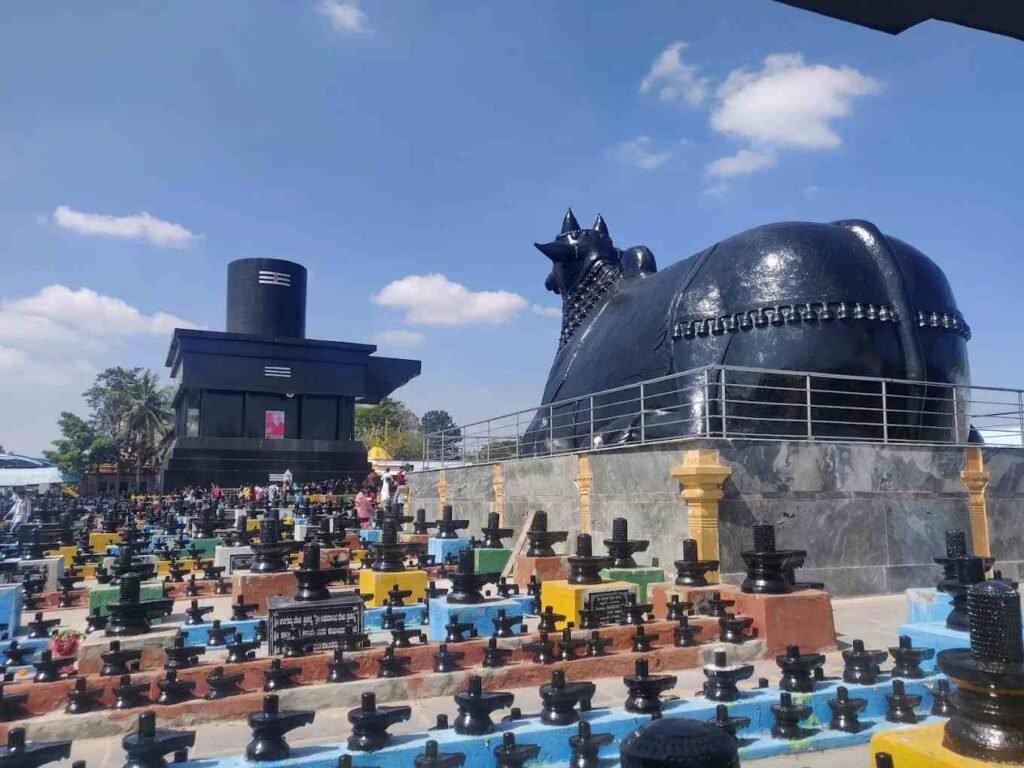 Massive Nandi statue at Kotilingeshwara Temple overlooking thousands of Shiva Lingas in Kolar, Karnataka.