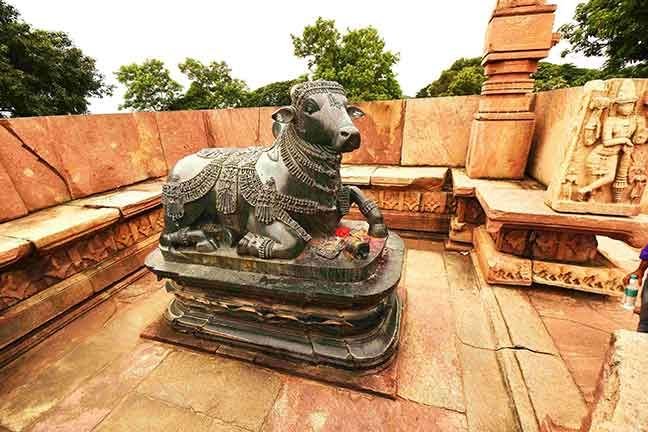 Ancient Nandi statue at Ramappa Temple in Warangal, intricately carved black stone bull facing the sanctum of Lord Shiva.