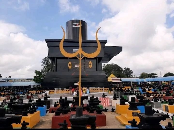 Gigantic Shiva Linga and golden Trishul at Kotilingeshwara Temple surrounded by thousands of Shiva Lingas.