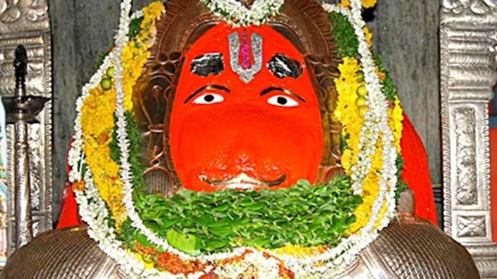 Sacred idol of Lord Hanuman at Karmanghat Hanuman Temple Hyderabad adorned with flowers, betel leaves, and traditional decorations.
