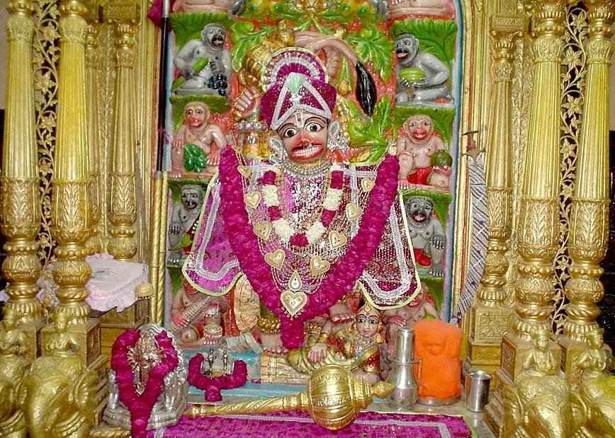Decorated idol of Kashtabhanjan Hanuman with floral garlands and golden shrine at Salangpur Hanuman Temple, Gujarat.