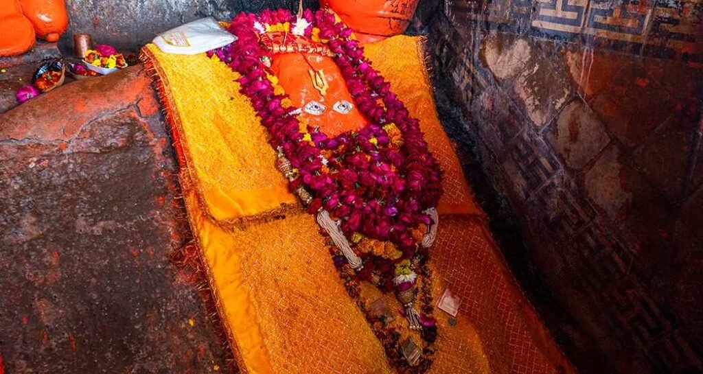 Close-up view of Lord Hanuman's idol at Hanuman Dhara Temple decorated with flower garlands in Chitrakoot.